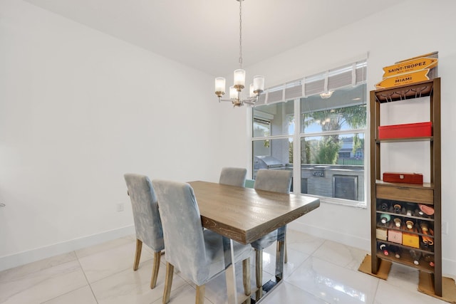 dining space featuring a notable chandelier and baseboards