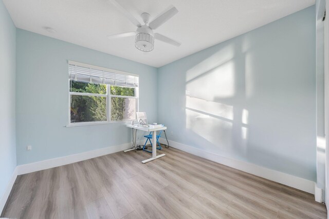 unfurnished room with ceiling fan and light hardwood / wood-style flooring