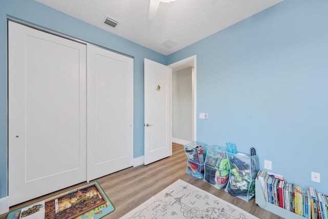 recreation room with light wood finished floors and visible vents