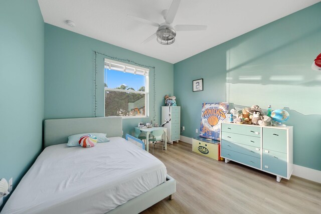 bedroom with ceiling fan and light hardwood / wood-style flooring