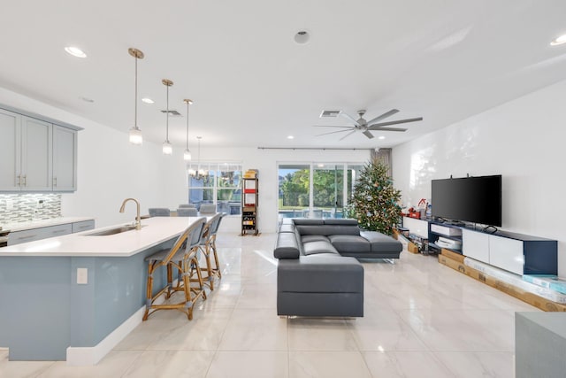 living room with recessed lighting, visible vents, and ceiling fan with notable chandelier