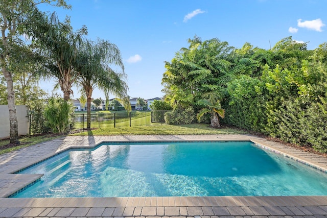 view of swimming pool with a fenced backyard, a fenced in pool, and a yard