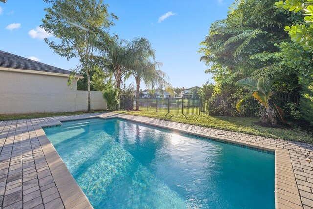 view of pool featuring a yard