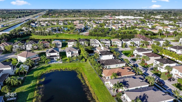 birds eye view of property featuring a water view and a residential view