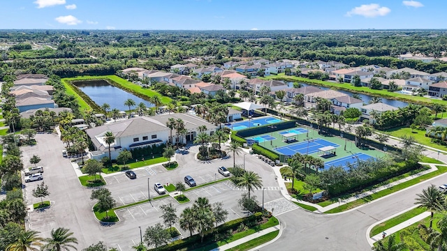 drone / aerial view featuring a water view and a residential view