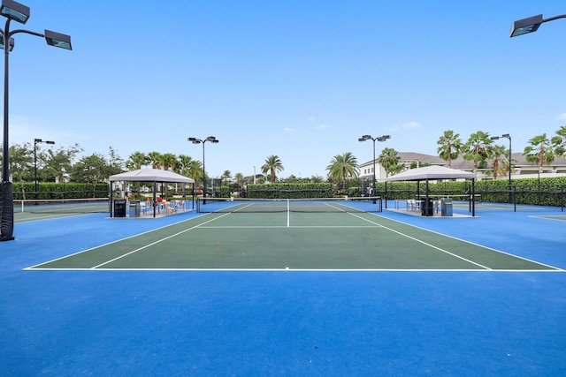 view of sport court featuring a gazebo and fence