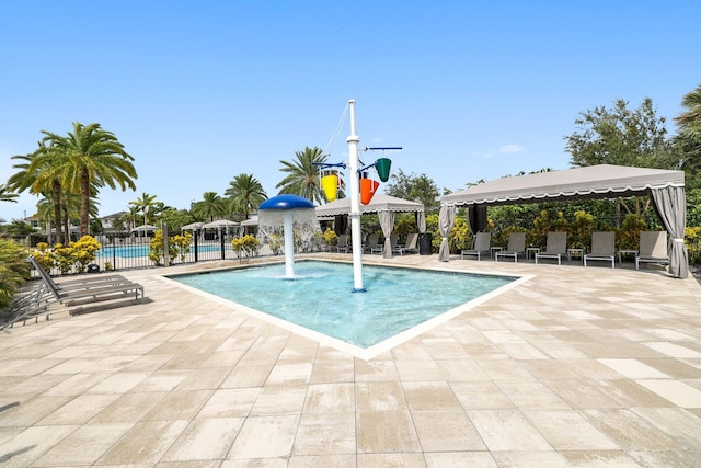 community pool featuring a patio area, fence, and a gazebo