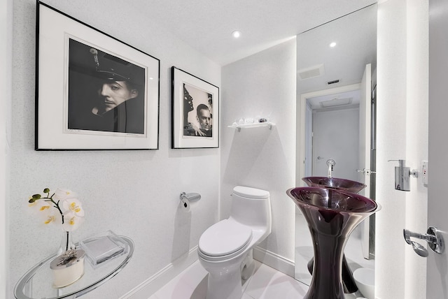 bathroom featuring tile patterned flooring and toilet