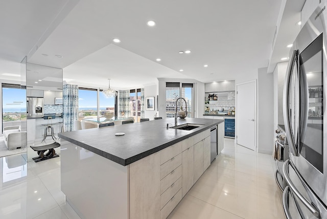 kitchen featuring a large island, sink, tasteful backsplash, pendant lighting, and appliances with stainless steel finishes