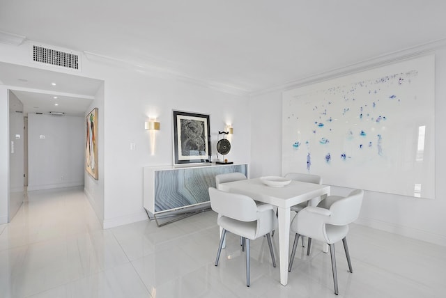 dining room featuring crown molding