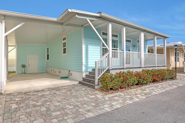 view of front of house with a carport and covered porch