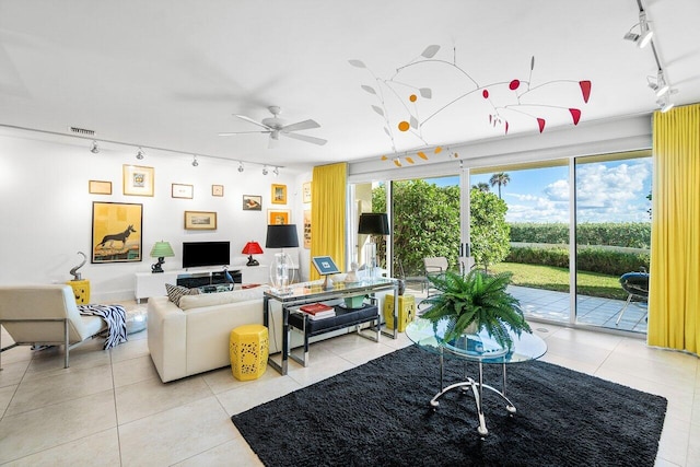 living room with ceiling fan, light tile patterned floors, and track lighting