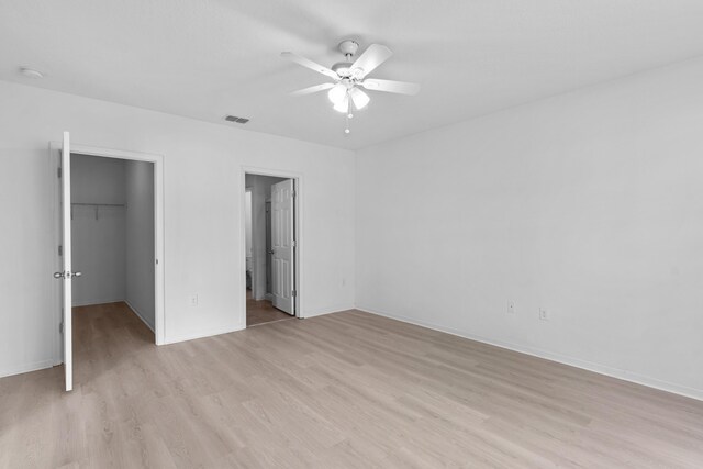 spare room featuring a wealth of natural light, ceiling fan, and light colored carpet