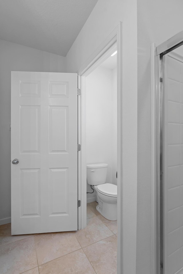 bathroom featuring tile patterned flooring and toilet