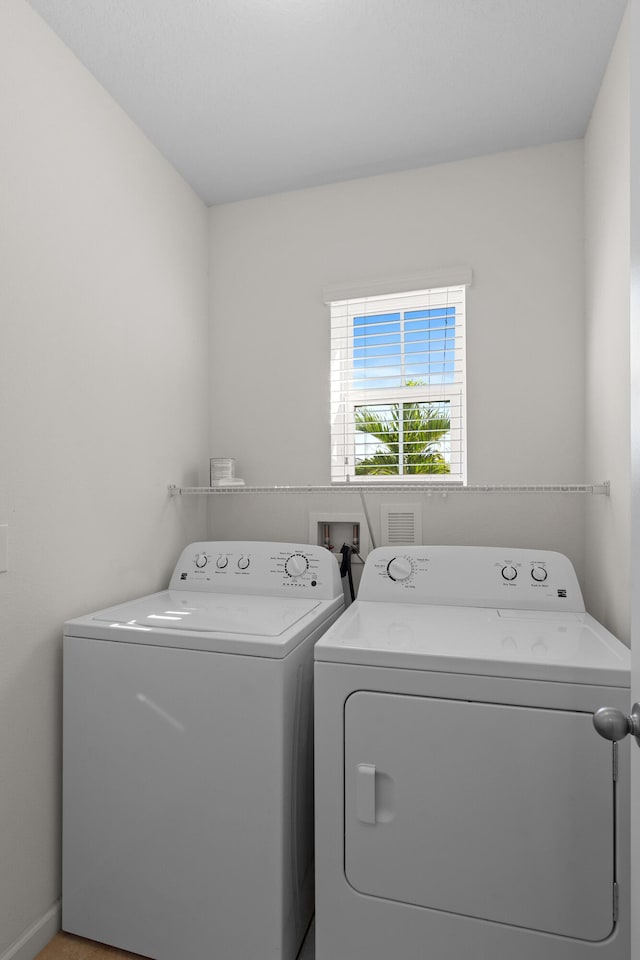 clothes washing area with washer and dryer