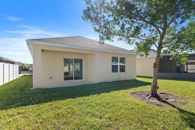 rear view of property featuring a yard