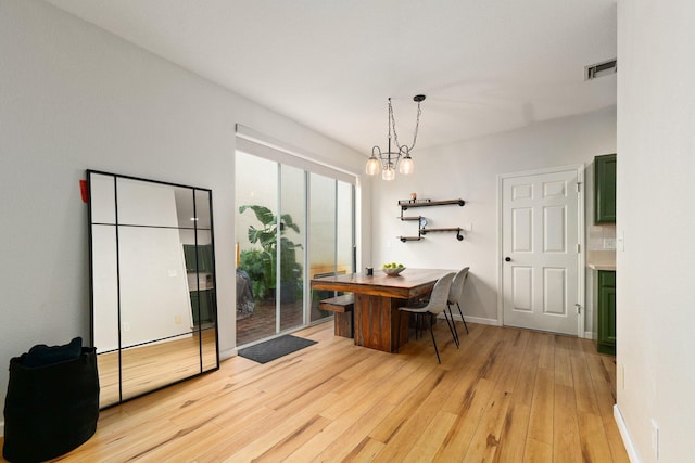 dining room featuring a chandelier and light wood-type flooring