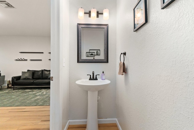 bathroom featuring hardwood / wood-style flooring and sink