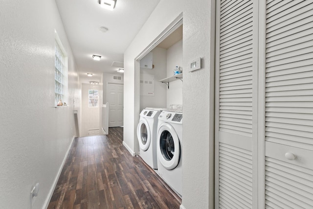 clothes washing area with dark hardwood / wood-style flooring and separate washer and dryer