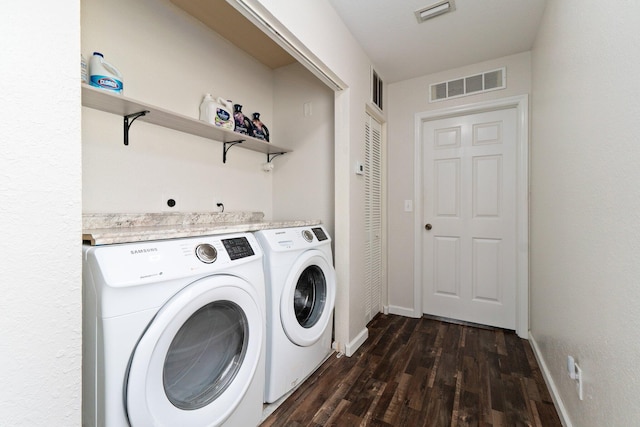 clothes washing area featuring dark hardwood / wood-style floors and independent washer and dryer