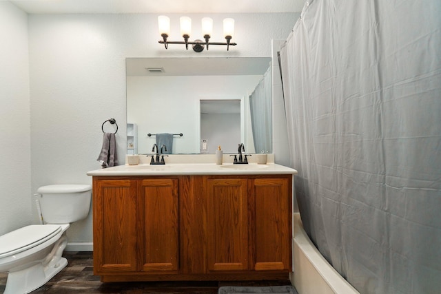 full bathroom with an inviting chandelier, hardwood / wood-style floors, toilet, shower / tub combo with curtain, and vanity