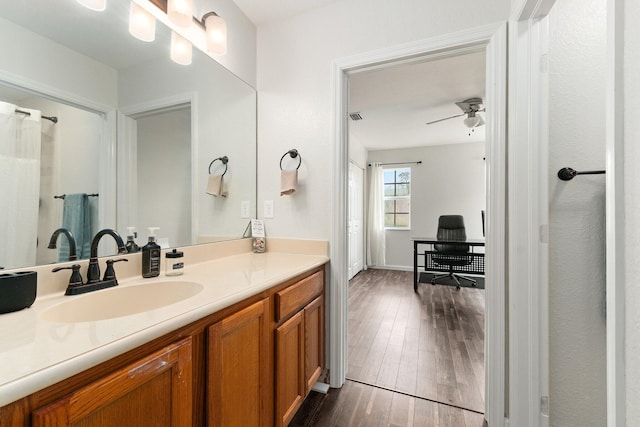 bathroom with ceiling fan, hardwood / wood-style floors, and vanity