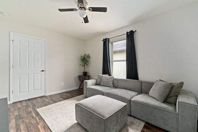 living room featuring ceiling fan and dark hardwood / wood-style flooring