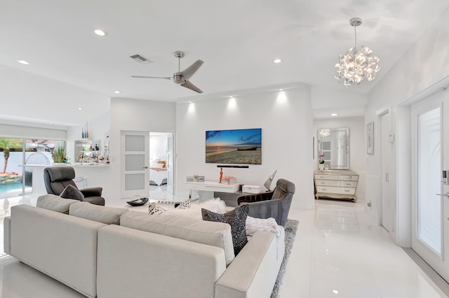 living room featuring ceiling fan with notable chandelier