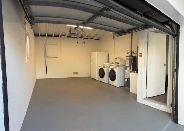 interior space with washing machine and clothes dryer and water heater