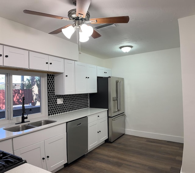 kitchen with white cabinetry, sink, stainless steel appliances, and dark hardwood / wood-style floors