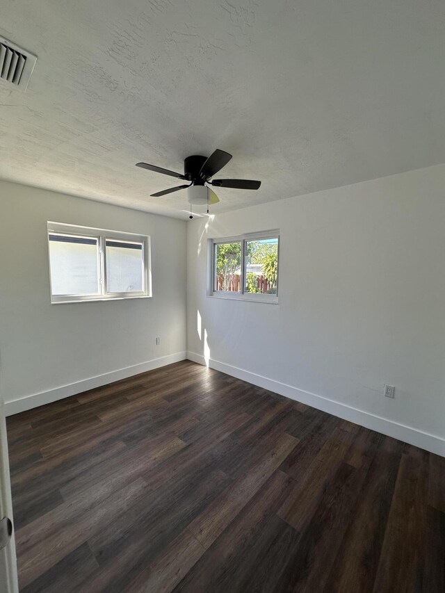 bathroom featuring hardwood / wood-style flooring, vanity, toilet, and a tile shower