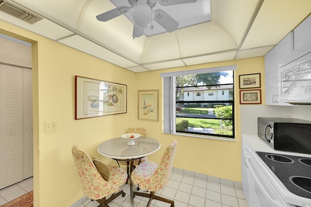 tiled dining room featuring a paneled ceiling and ceiling fan