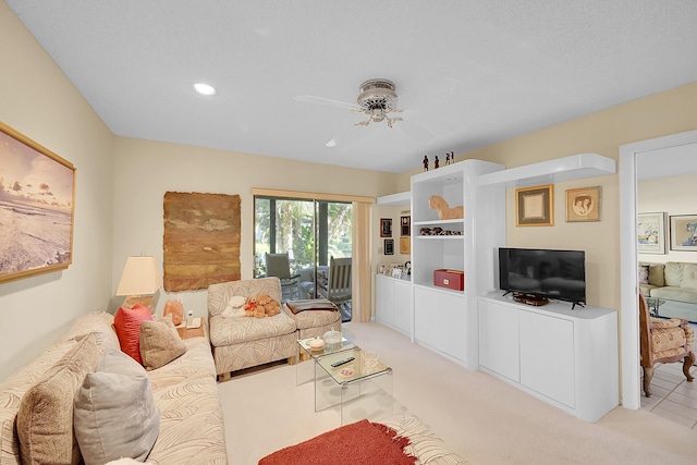 carpeted living room with ceiling fan