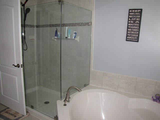 bathroom featuring plus walk in shower