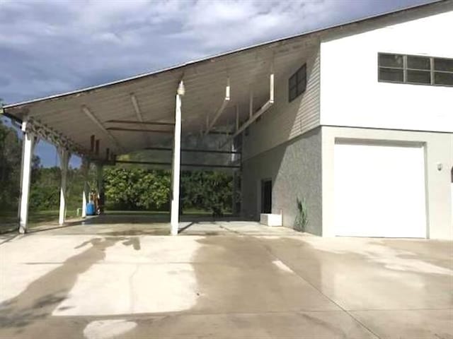 view of car parking with a carport and a garage