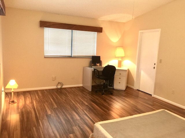 unfurnished office with vaulted ceiling and dark wood-type flooring