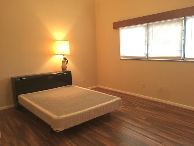 bedroom featuring dark wood-type flooring