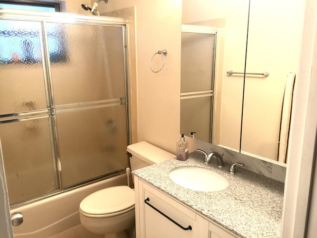 full bathroom with vanity, toilet, and bath / shower combo with glass door