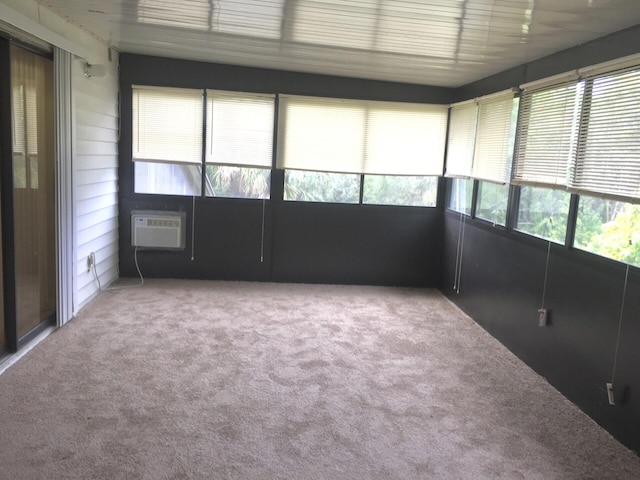 unfurnished sunroom with a wall mounted AC