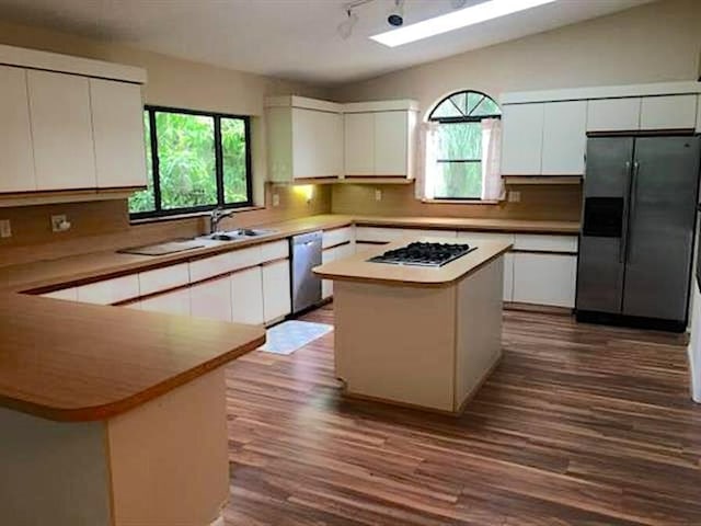 kitchen featuring white cabinets, a kitchen island, and appliances with stainless steel finishes