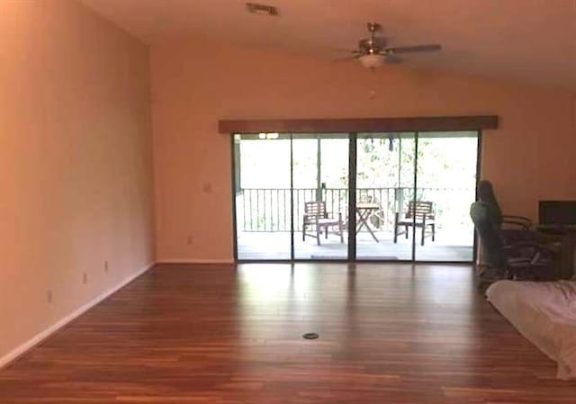 unfurnished living room featuring hardwood / wood-style floors, plenty of natural light, ceiling fan, and vaulted ceiling