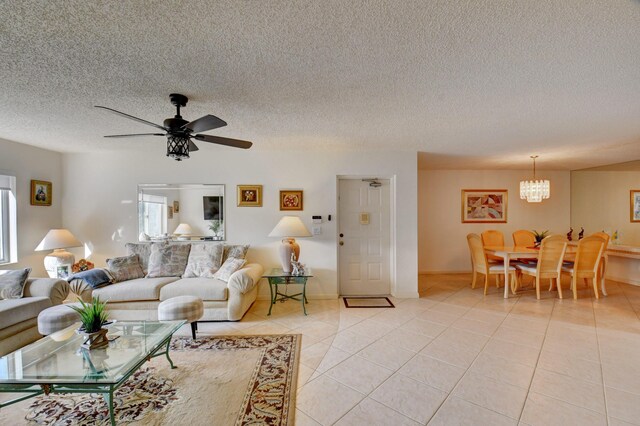 tiled living room featuring ceiling fan and a textured ceiling