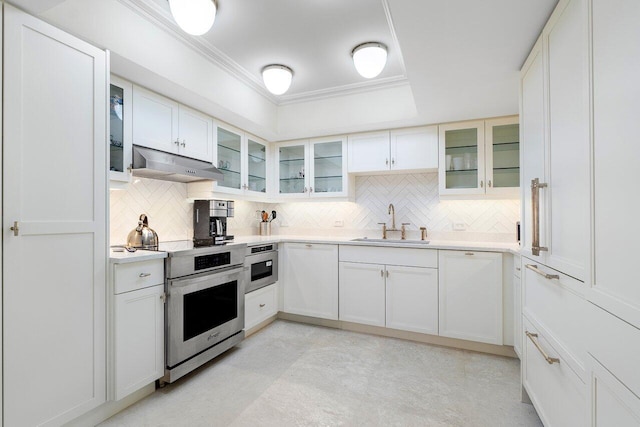 kitchen featuring sink, white cabinets, stainless steel appliances, and ornamental molding