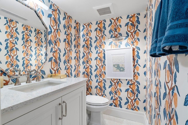 bathroom with tile patterned flooring, vanity, and toilet