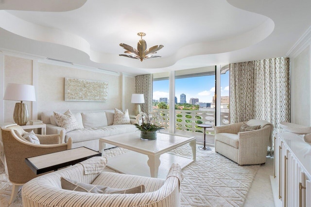 living room with crown molding and a tray ceiling