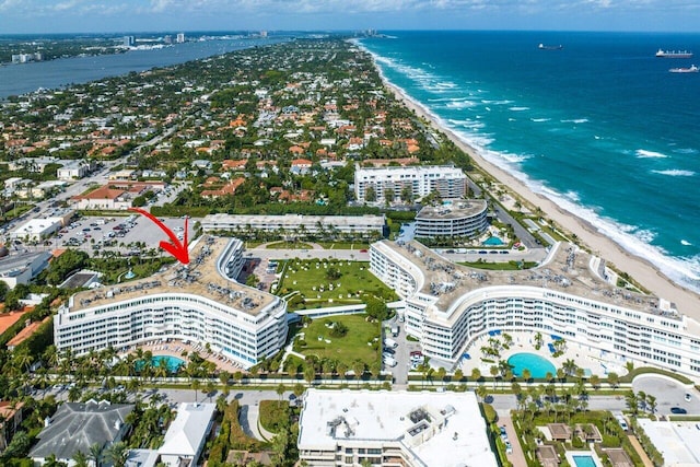 drone / aerial view with a water view and a beach view