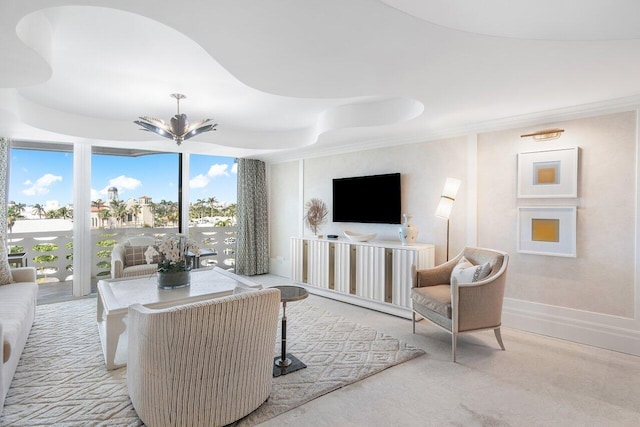 carpeted living room with an inviting chandelier