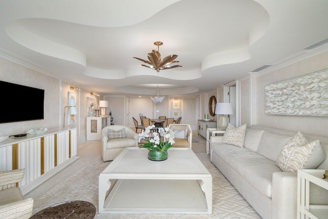 carpeted living room with a raised ceiling, ceiling fan, and ornamental molding