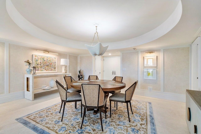 dining area with a raised ceiling and light colored carpet