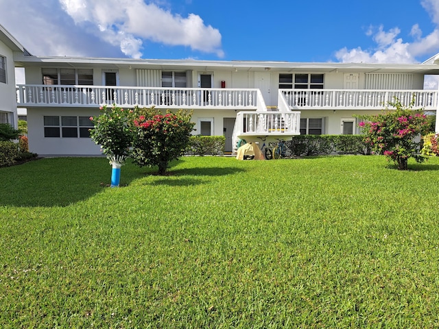 rear view of house with a yard